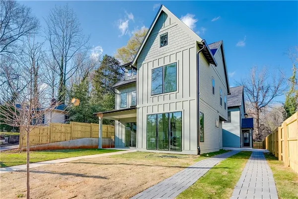 a living room with furniture kitchen view and a wooden floor