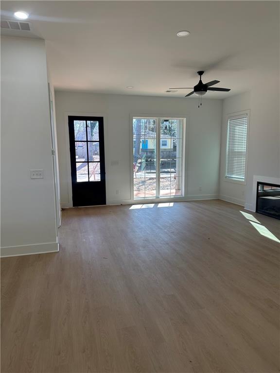 Undisclosed Address Atlanta, GA 30310 - Photo 6 of 25 an empty room with windows and ceiling fan