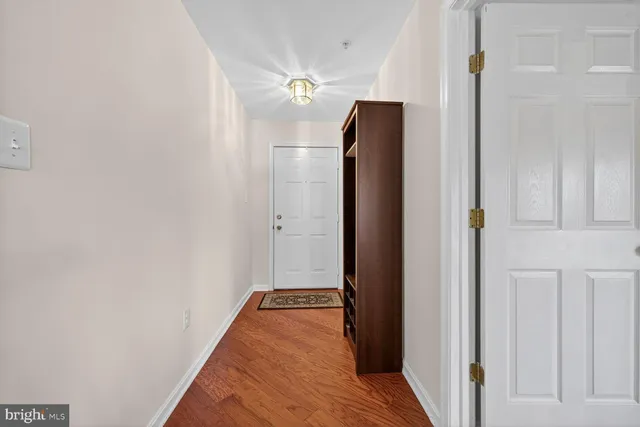a view of hallway with wooden floor
