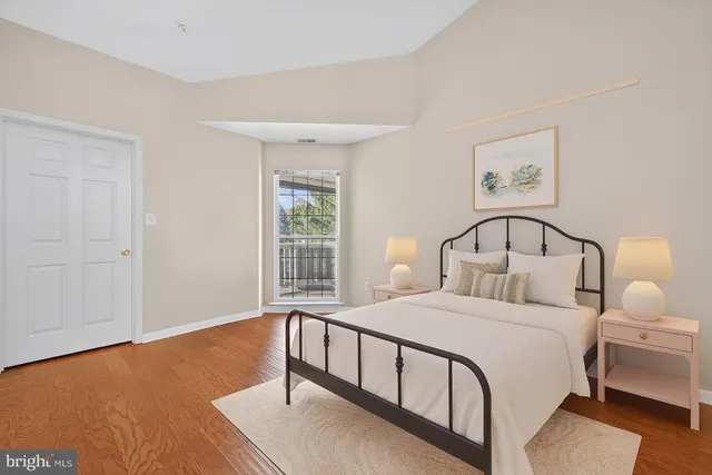 a bedroom with a large bed and a window