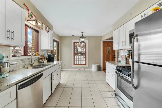 a kitchen with stainless steel appliances a sink stove and cabinets