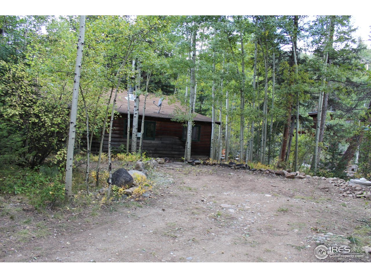 223 Riverside Drive Lyons, CO 80540 - Photo 24 of 33 Parking area with rear north entrance to cabin