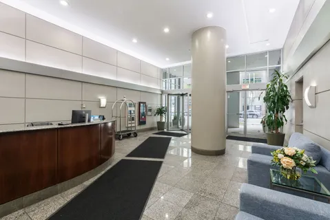 a lobby with furniture and potted plant