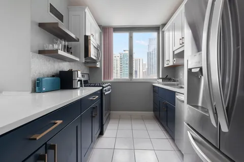 a kitchen with stainless steel appliances a sink stove and a refrigerator