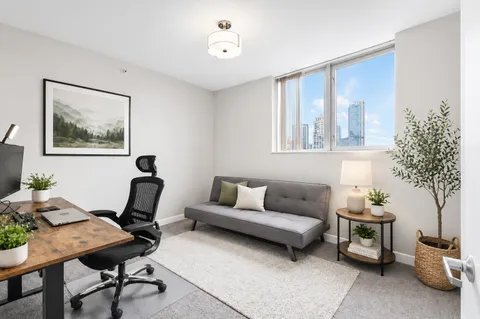 a living room with furniture and a potted plant