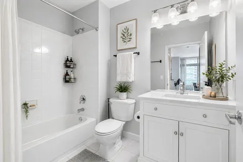 a bathroom with a sink a toilet and shower