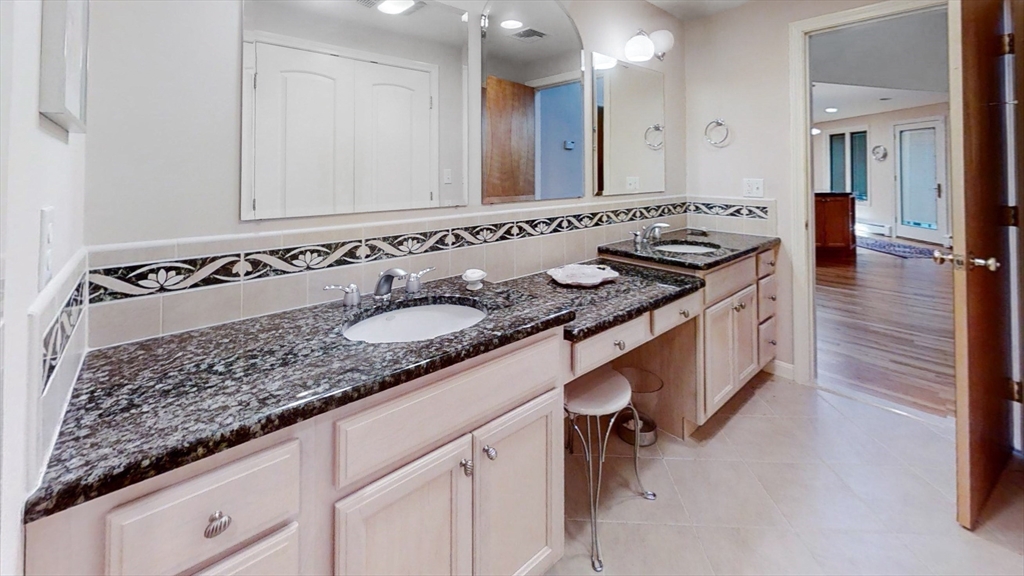 30 Tyler Road Lexington, MA 02420 - Photo 18 of 40 a bathroom with a granite countertop sink and a mirror