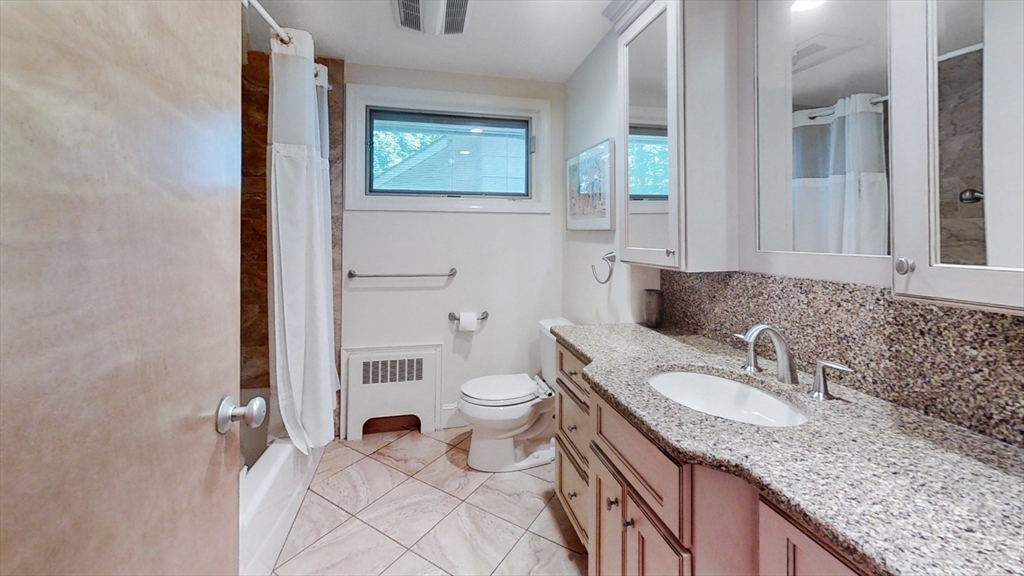 30 Tyler Road Lexington, MA 02420 - Photo 22 of 40 a bathroom with a granite countertop sink and a mirror