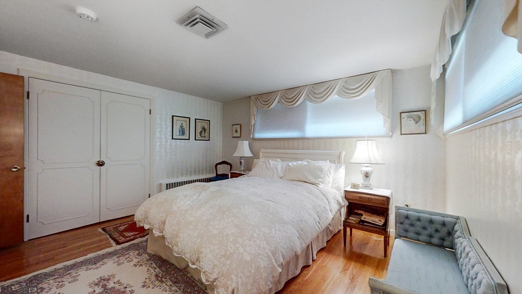 30 Tyler Road Lexington, MA 02420 - Photo 24 of 40 a bedroom with a bed and wooden floor
