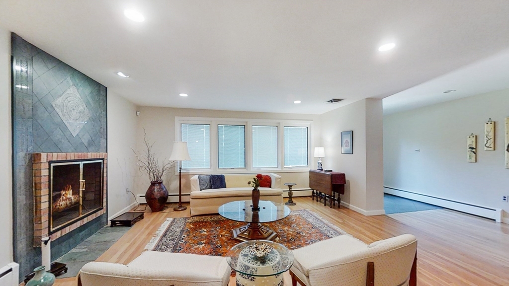30 Tyler Road Lexington, MA 02420 - Photo 5 of 40 a living room with fireplace furniture and a wooden floor