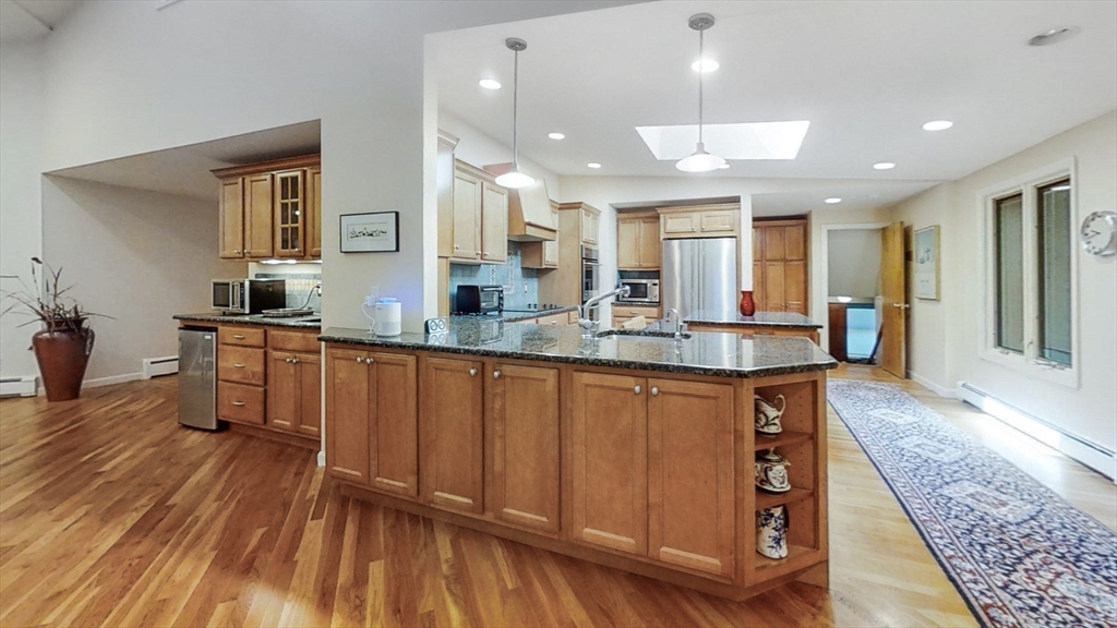 30 Tyler Road Lexington, MA 02420 - Photo 8 of 40 a large kitchen with kitchen island granite countertop wooden floors and a sink