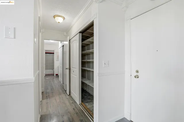 a view of a hallway with wooden floor
