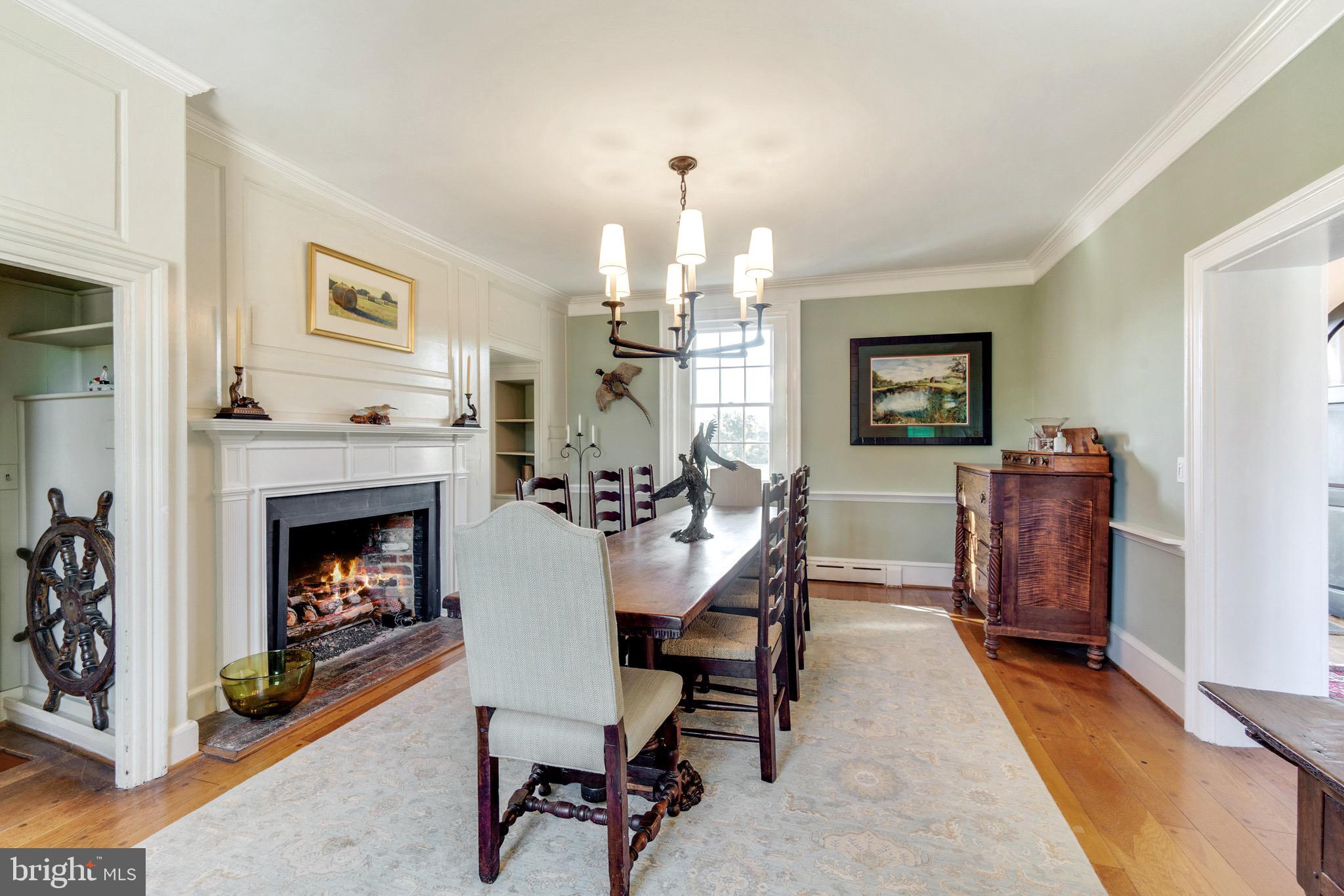6029 Edesville Road Rock Hall, MD 21661 - Photo 23 of 75 Dining room with gas fireplace and new chandelier