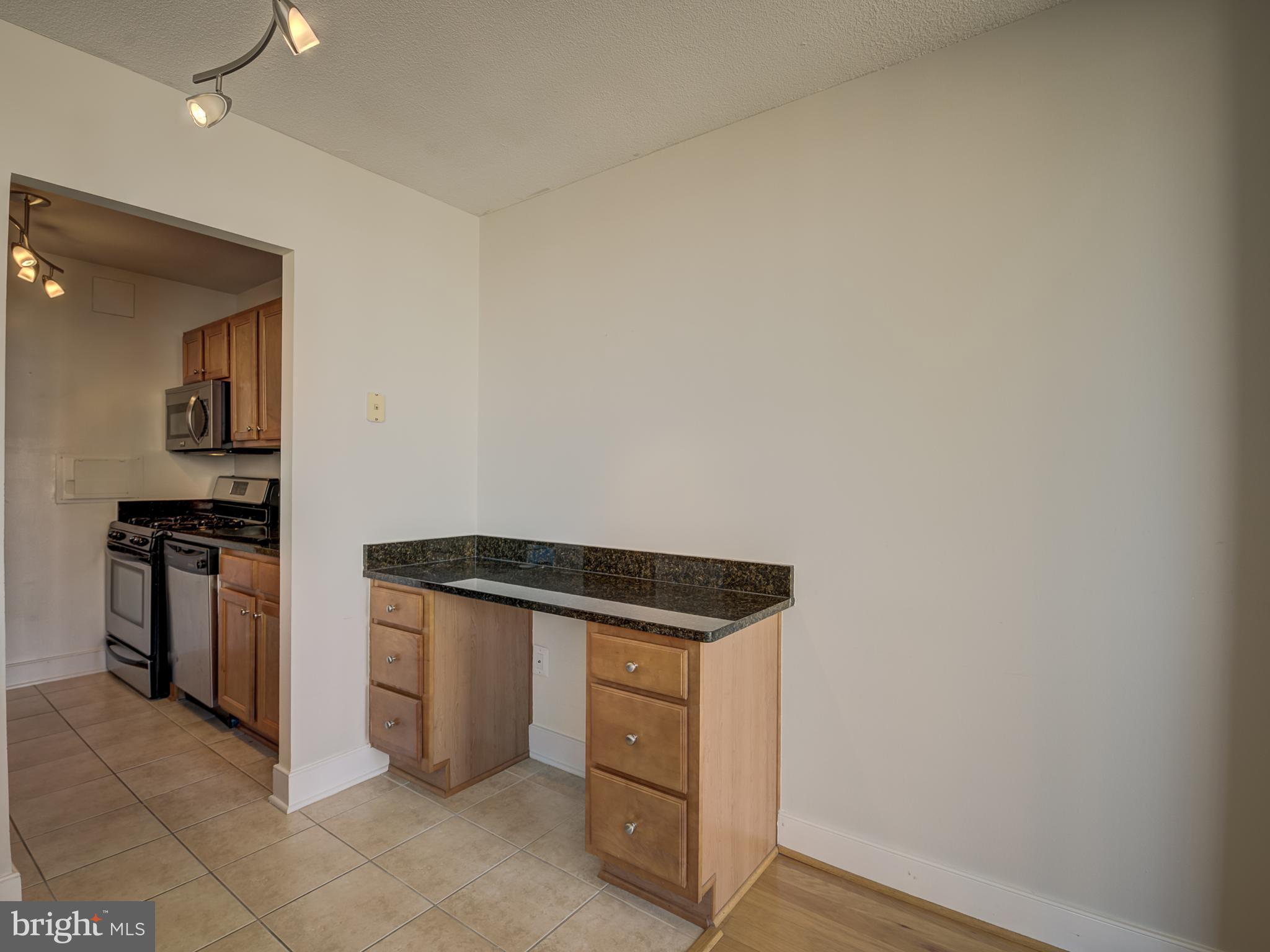 1220 Blair Mill Road, Unit 902 Silver Spring, MD 20910 - Photo 13 of 48 a kitchen with stainless steel appliances granite countertop a stove and a refrigerator