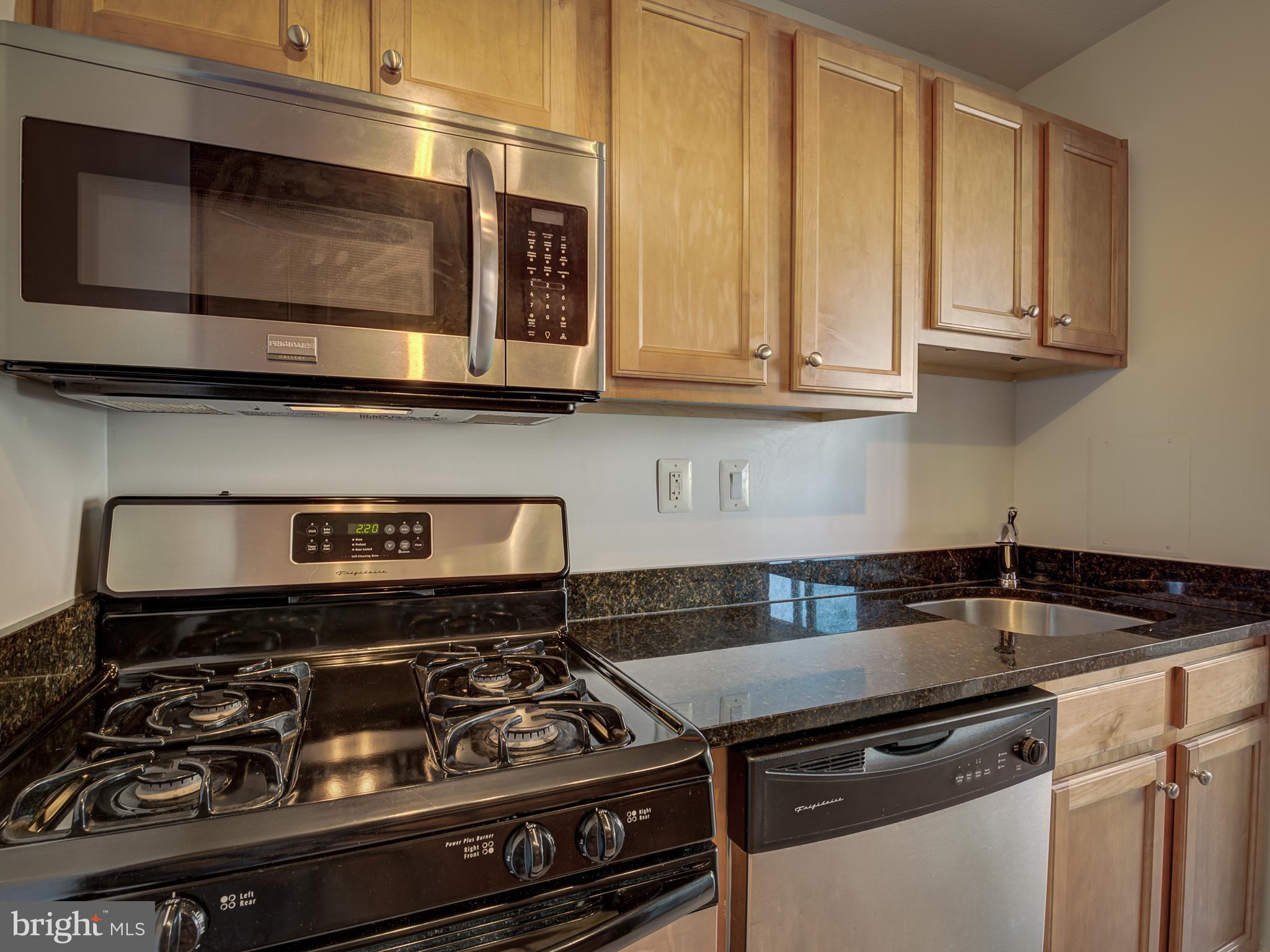 1220 Blair Mill Road, Unit 902 Silver Spring, MD 20910 - Photo 22 of 48 a kitchen with a stove and a microwave