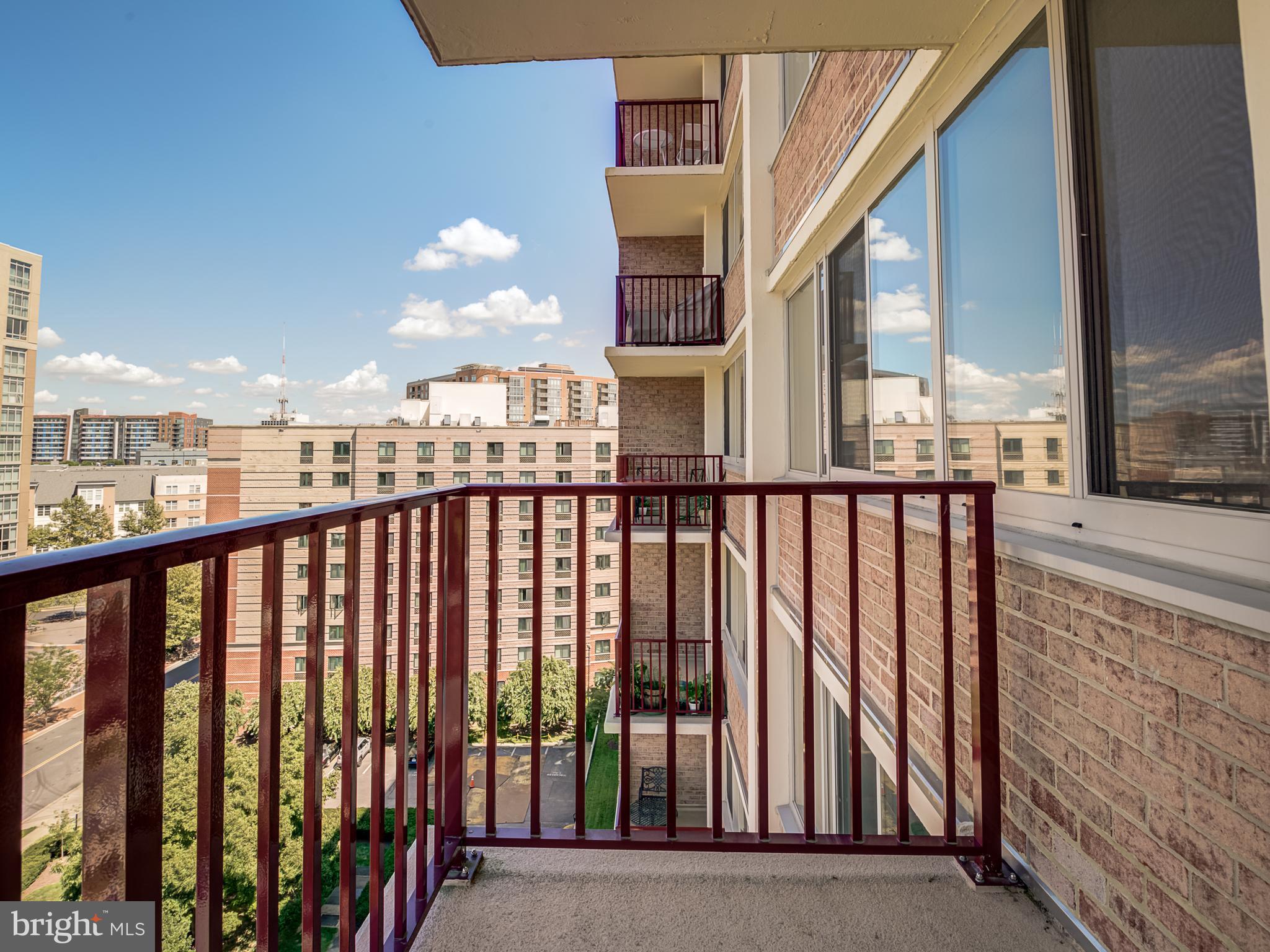1220 Blair Mill Road, Unit 902 Silver Spring, MD 20910 - Photo 24 of 48 a view of a balcony with a floor to ceiling window next to a tall building