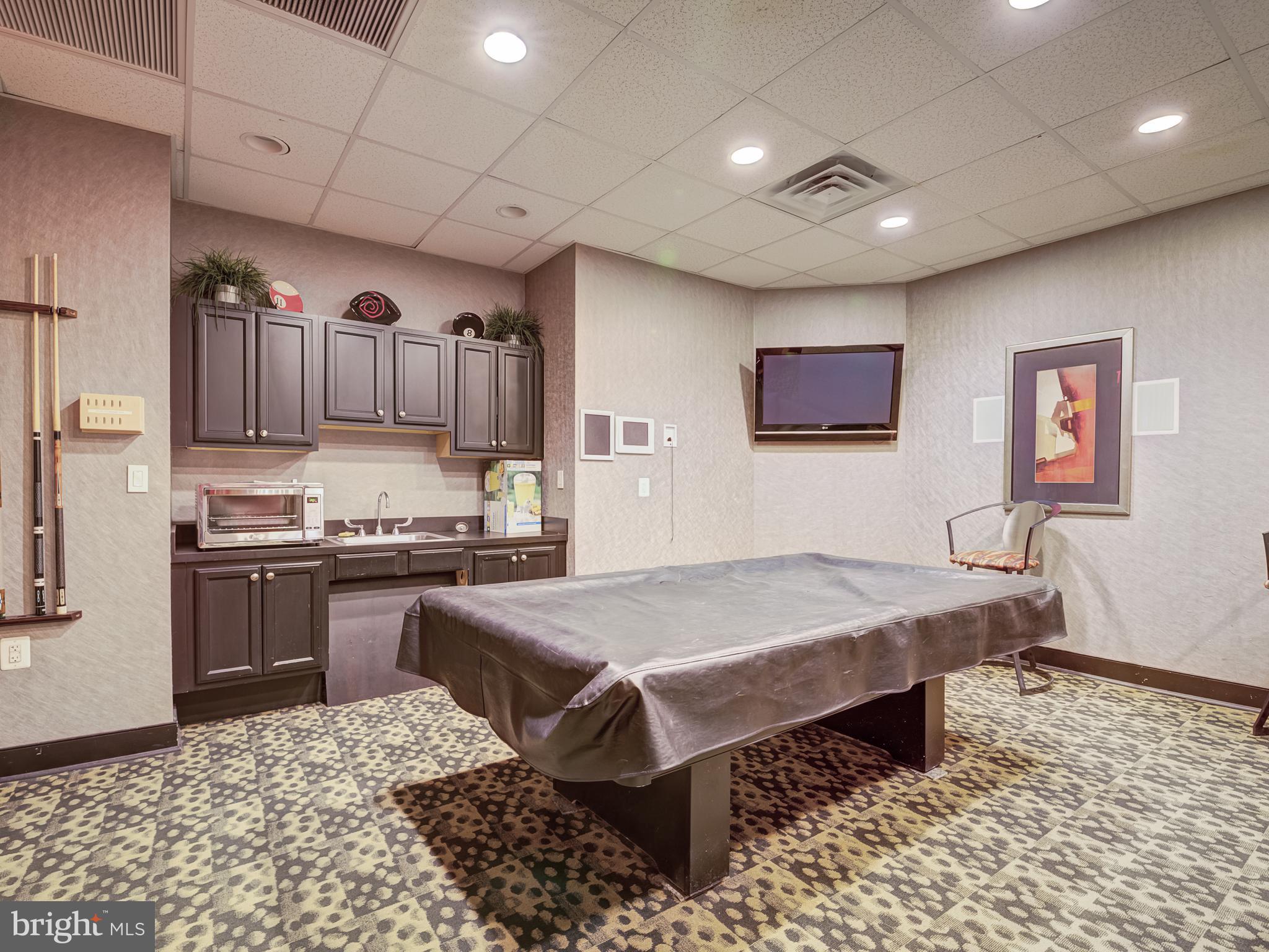 1220 Blair Mill Road, Unit 902 Silver Spring, MD 20910 - Photo 40 of 48 a kitchen with stainless steel appliances granite countertop a stove a sink dishwasher and a refrigerator with wooden floor