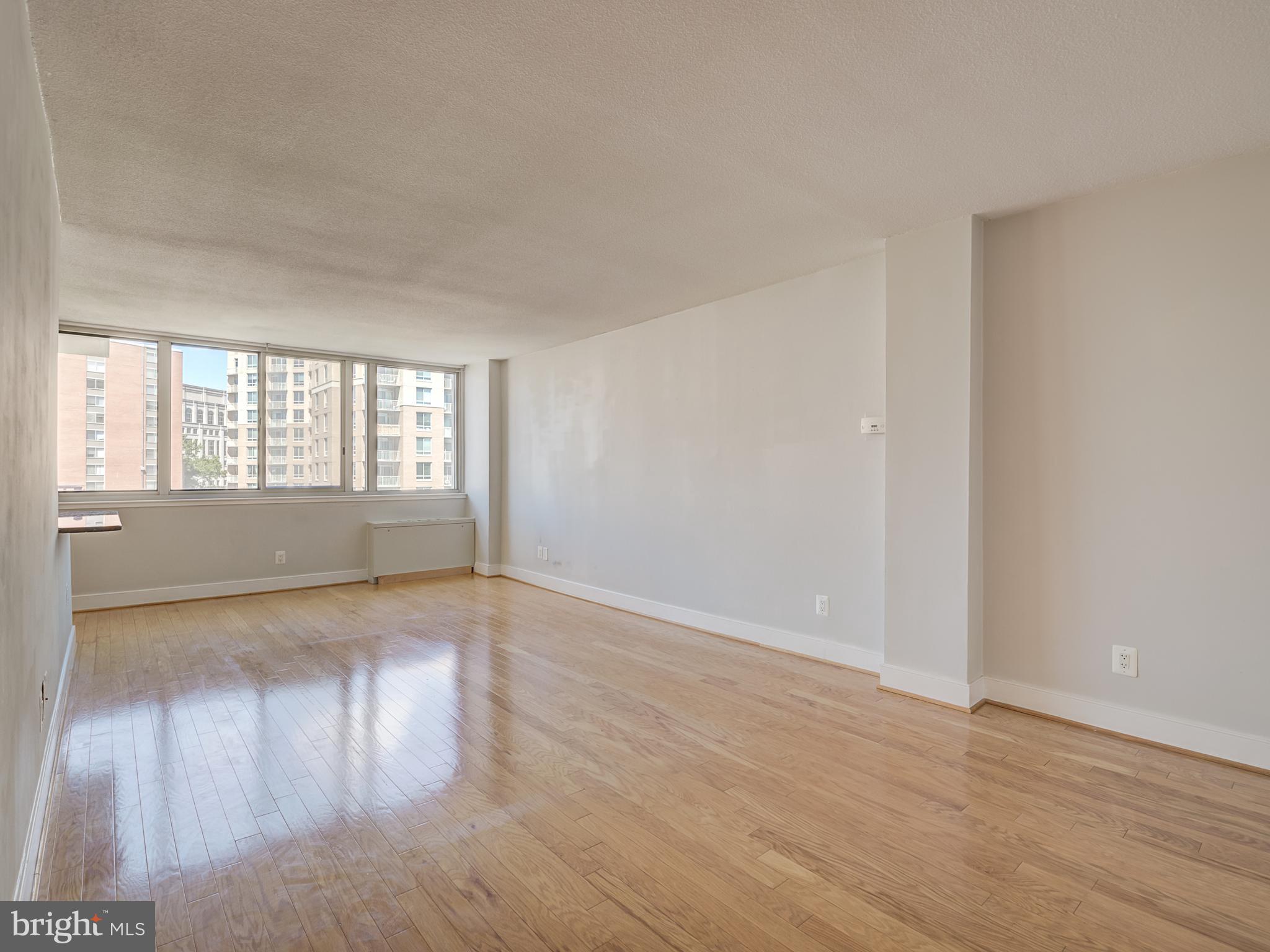 1220 Blair Mill Road, Unit 902 Silver Spring, MD 20910 - Photo 6 of 48 a view of an empty room with wooden floor and a window