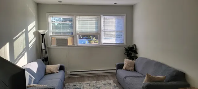 a living room with furniture and a window