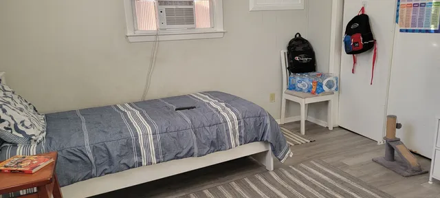 a bedroom with a bed and a window