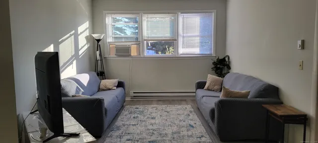 a kitchen with stainless steel appliances a stove a microwave a refrigerator and white cabinets