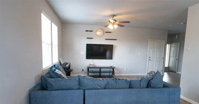 a living room with furniture and a flat screen tv