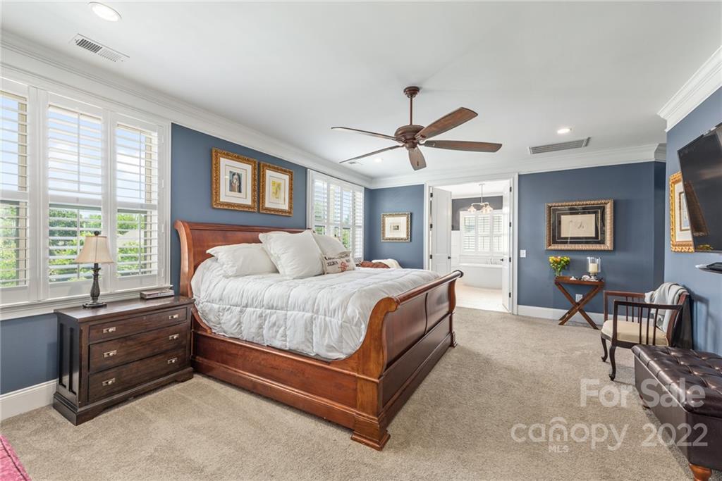 4040 Flowering Peach Road Marvin, NC 28173 - Photo 12 of 38 a spacious bedroom with a bed a chandelier and a dresser
