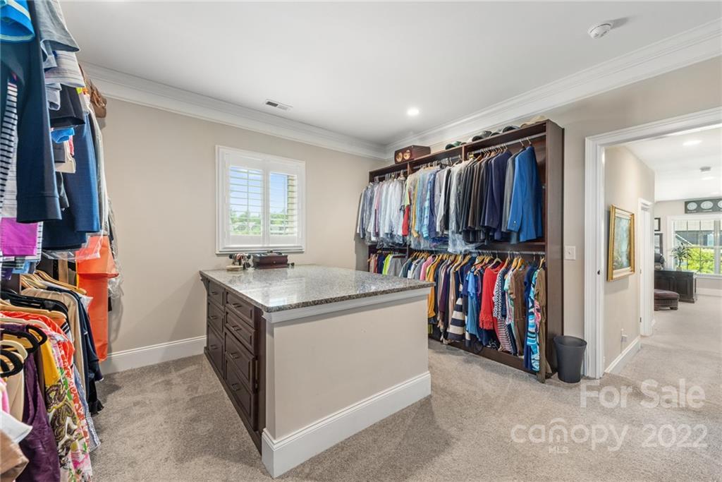 4040 Flowering Peach Road Marvin, NC 28173 - Photo 13 of 38 a view of walk in closet with clothes and shoes