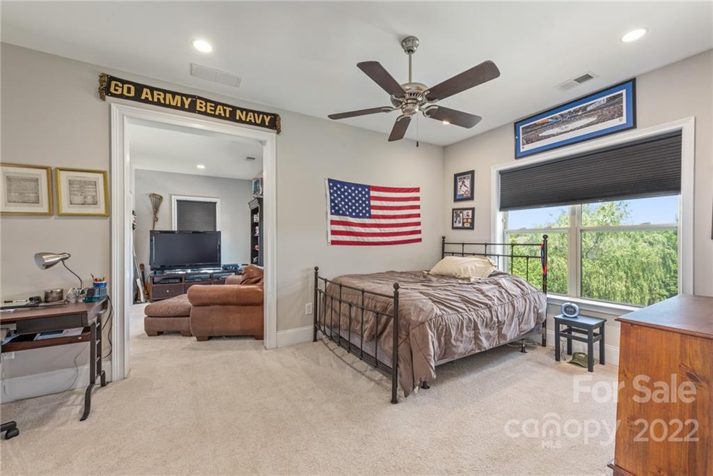 4040 Flowering Peach Road Marvin, NC 28173 - Photo 19 of 38 a bedroom with a bed and a chandelier