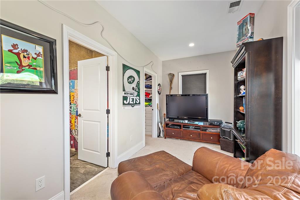 4040 Flowering Peach Road Marvin, NC 28173 - Photo 20 of 38 a bedroom with a bed and a flat screen tv