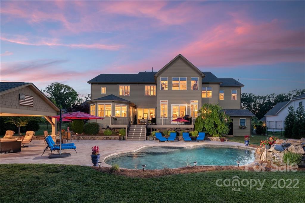 4040 Flowering Peach Road Marvin, NC 28173 - Photo 2 of 38 a front view of a house with swimming pool having outdoor seating
