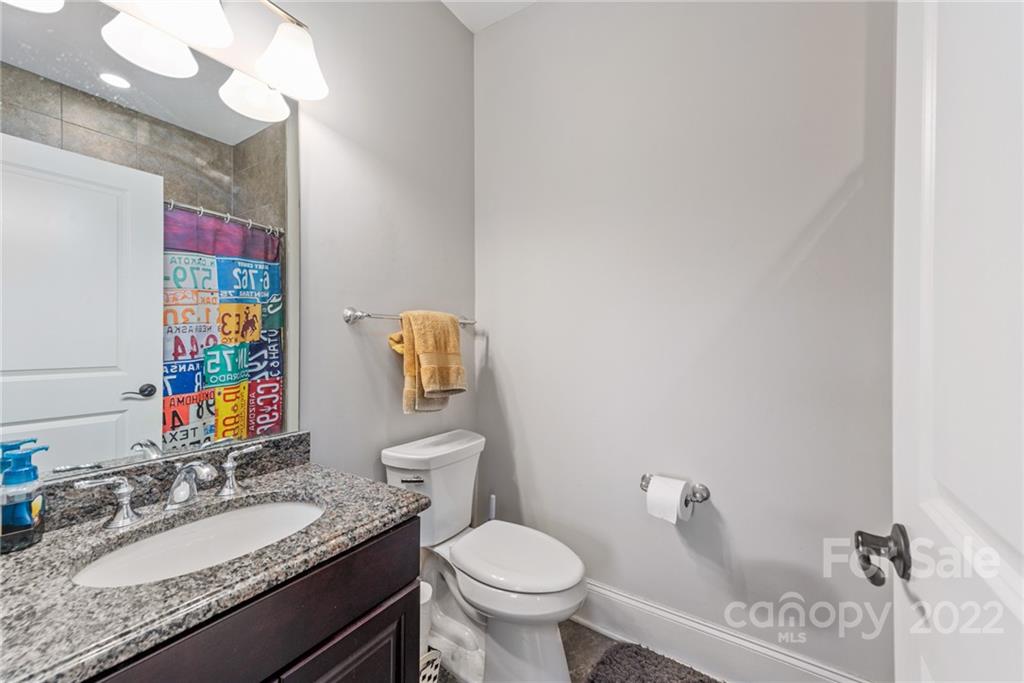 4040 Flowering Peach Road Marvin, NC 28173 - Photo 21 of 38 a bathroom with a granite countertop toilet sink and mirror