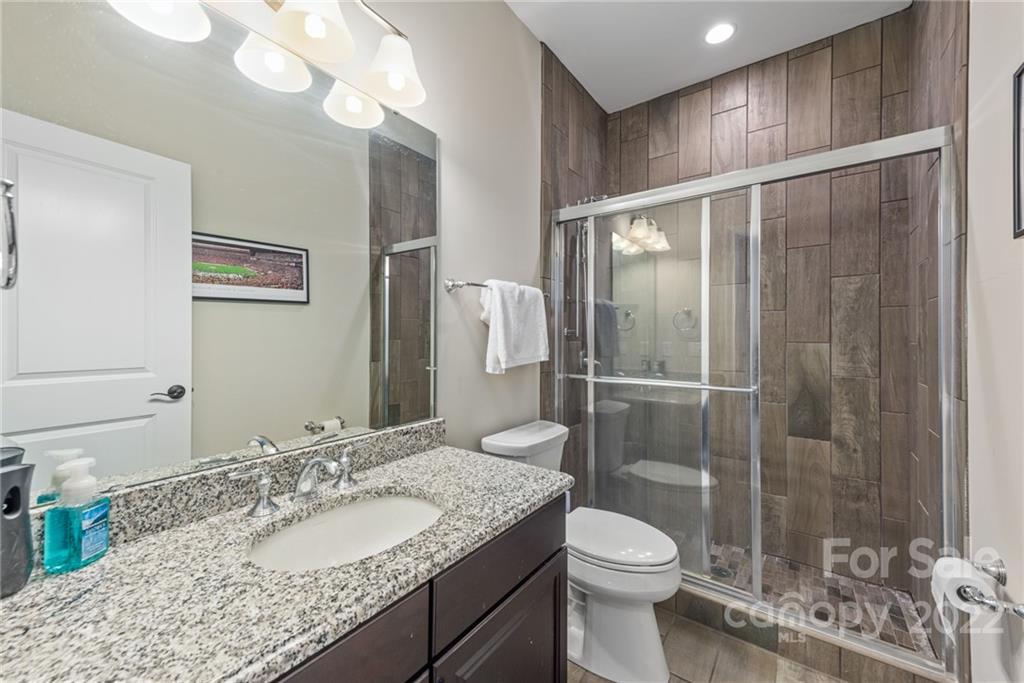 4040 Flowering Peach Road Marvin, NC 28173 - Photo 24 of 38 a bathroom with a granite countertop sink toilet and shower