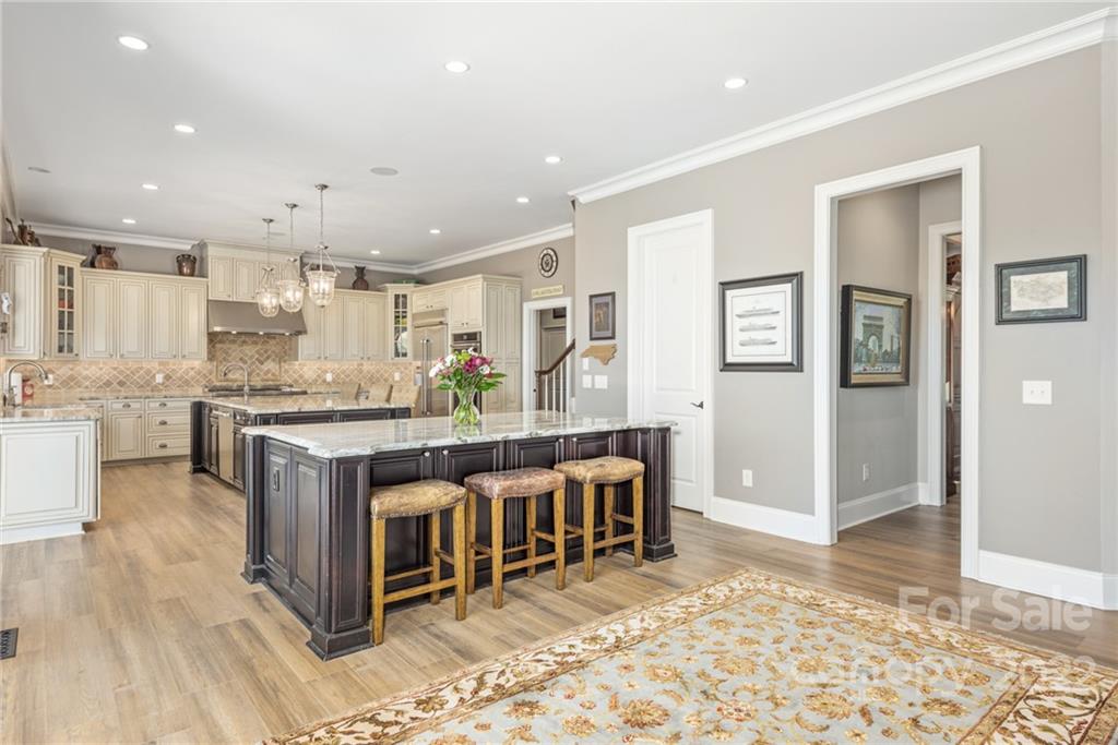 4040 Flowering Peach Road Marvin, NC 28173 - Photo 34 of 38 a kitchen with stainless steel appliances granite countertop a stove a sink and a refrigerator