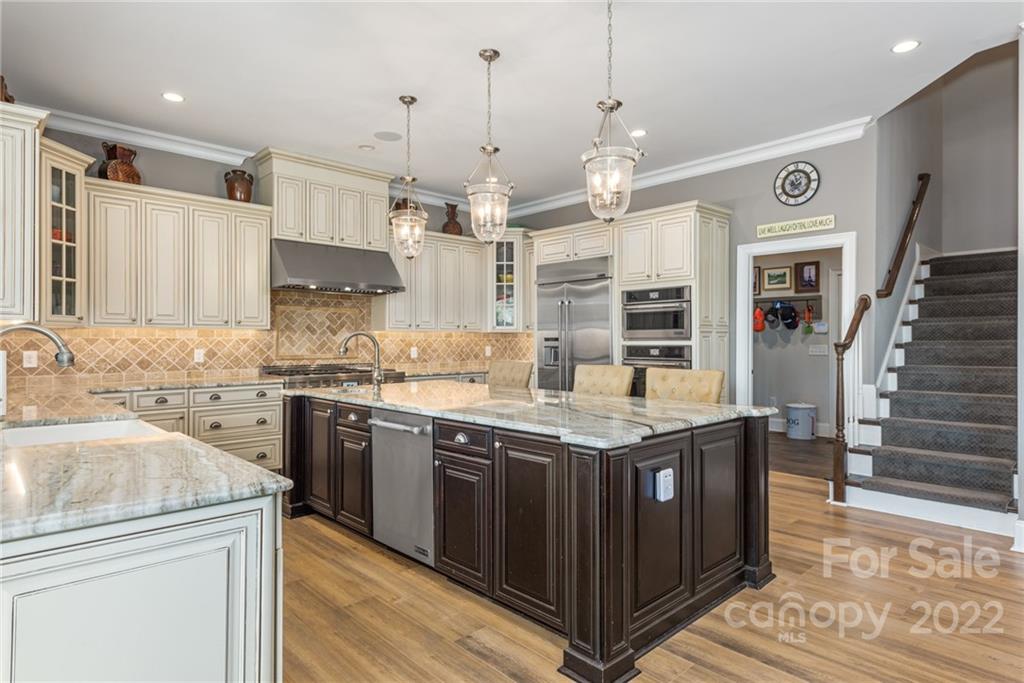 4040 Flowering Peach Road Marvin, NC 28173 - Photo 35 of 38 a kitchen with stainless steel appliances granite countertop a sink stove and refrigerator
