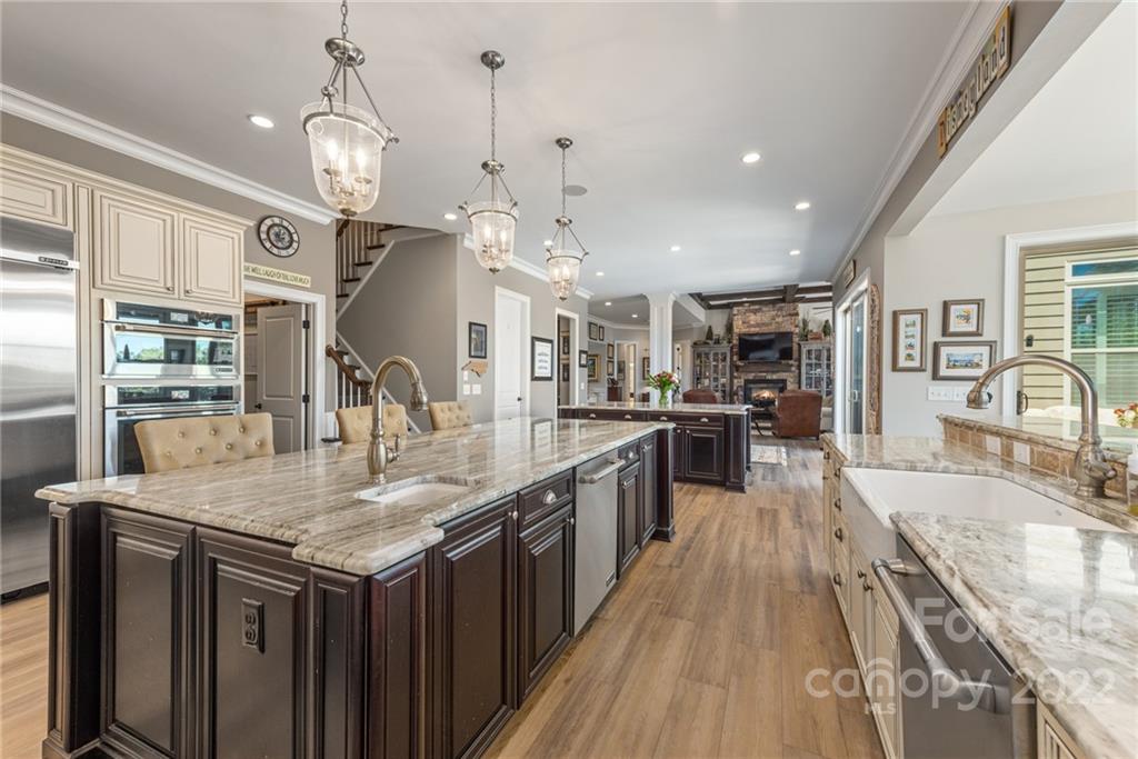 4040 Flowering Peach Road Marvin, NC 28173 - Photo 38 of 38 a large kitchen with granite countertop a large center island a sink stainless steel appliances and cabinets