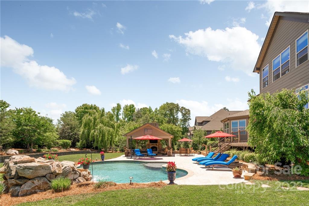 4040 Flowering Peach Road Marvin, NC 28173 - Photo 5 of 38 a swimming pool with outdoor seating and yard