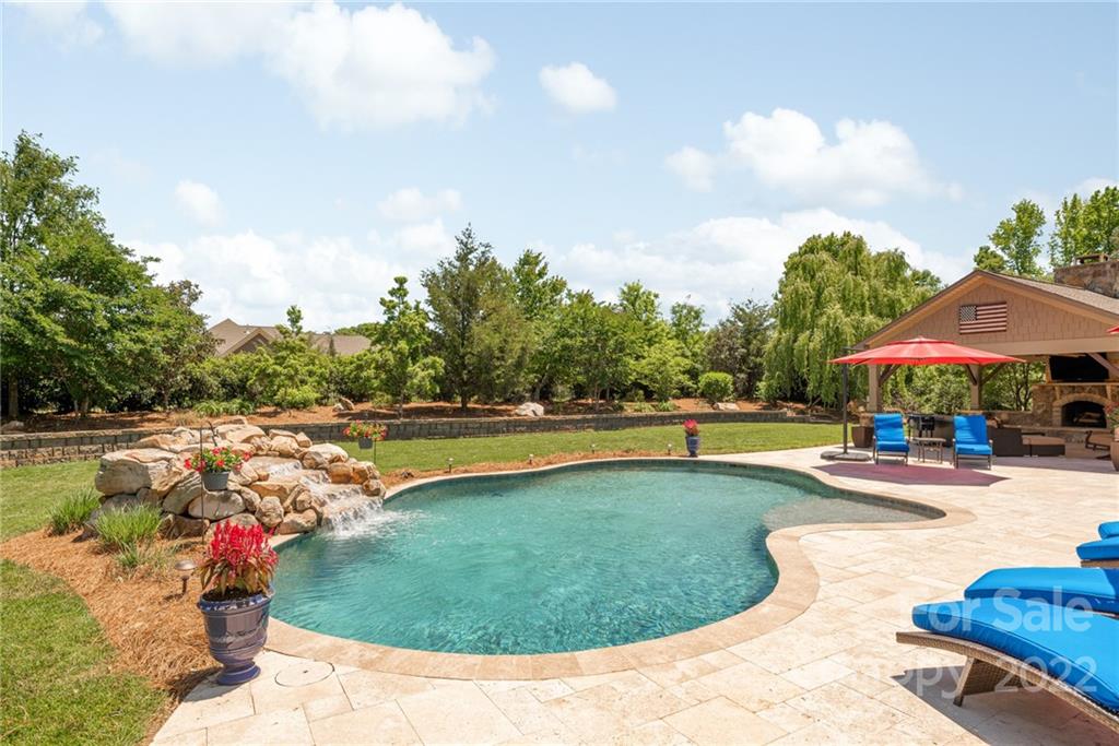 4040 Flowering Peach Road Marvin, NC 28173 - Photo 9 of 38 a view of a swimming pool and lounge chairs