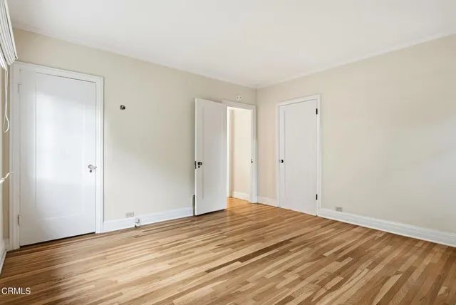 a view of empty room with wooden floor