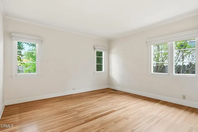 a bathroom with a granite countertop toilet sink and mirror