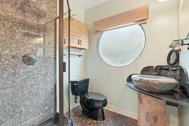 a view of kitchen and kitchen with granite countertop cabinets