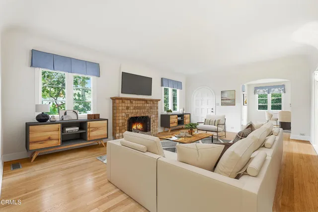 an empty room with windows and a fireplace