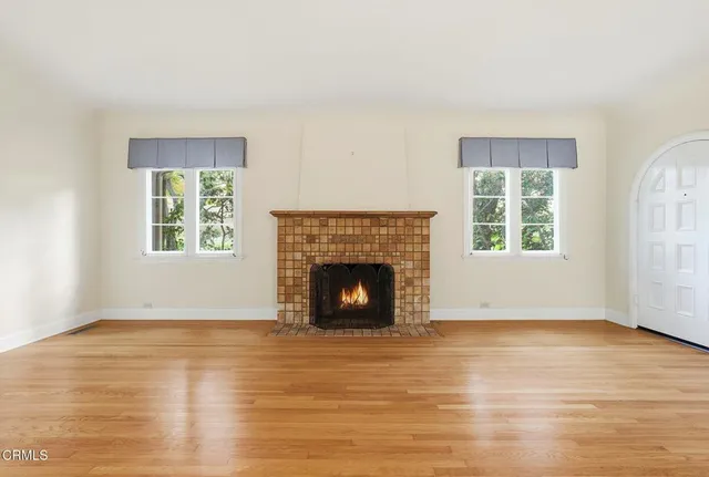 a living room with furniture chandelier and a mirror