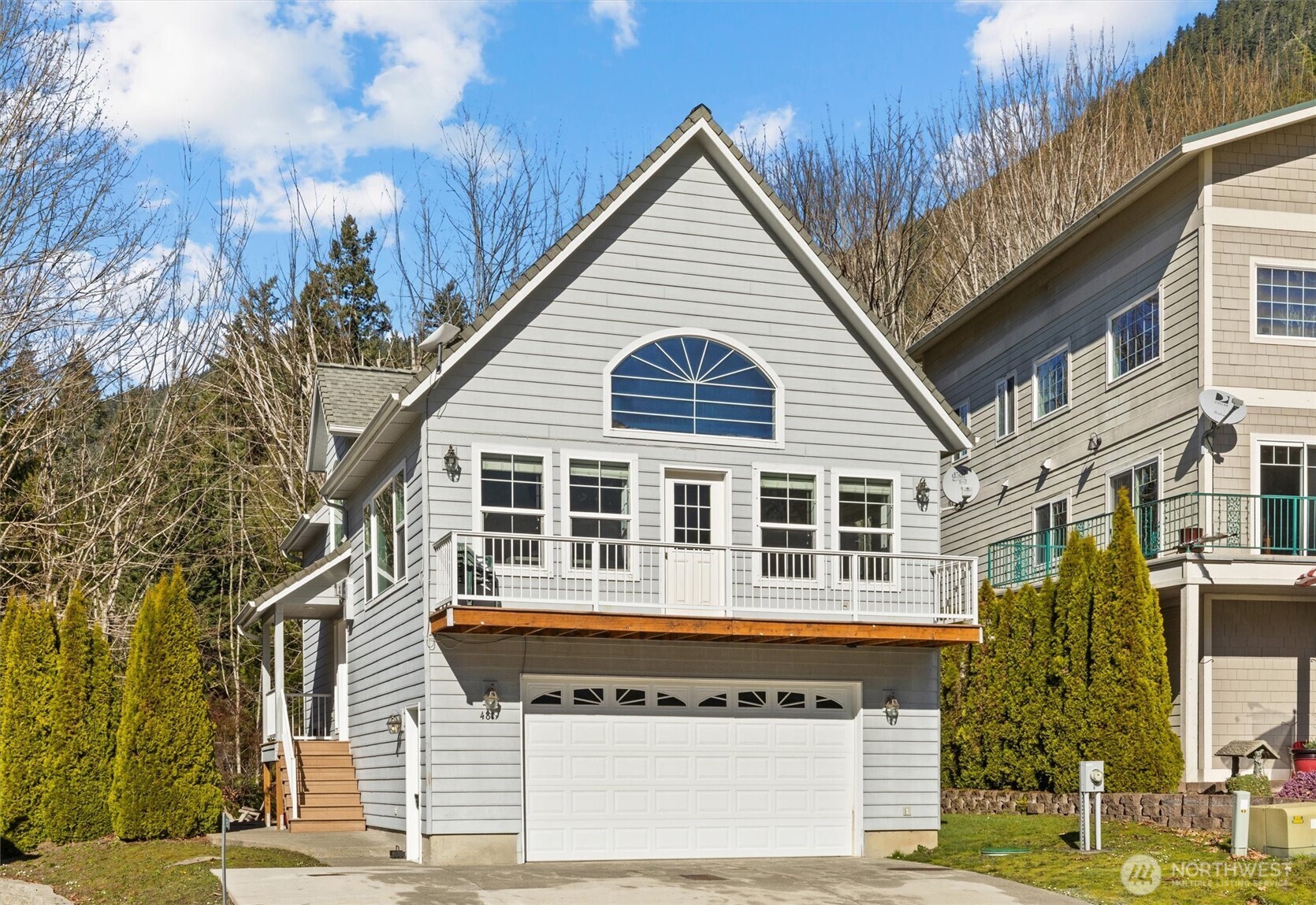 481 Maple Grove Road Port Angeles, WA 98363 - Photo 40 of 40 a view of a house with a garage and balcony