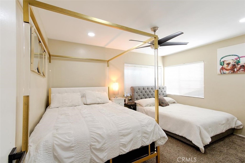 11523 Richeon Avenue Downey, CA 90241 - Photo 11 of 25 a bedroom with two beds and a chandelier