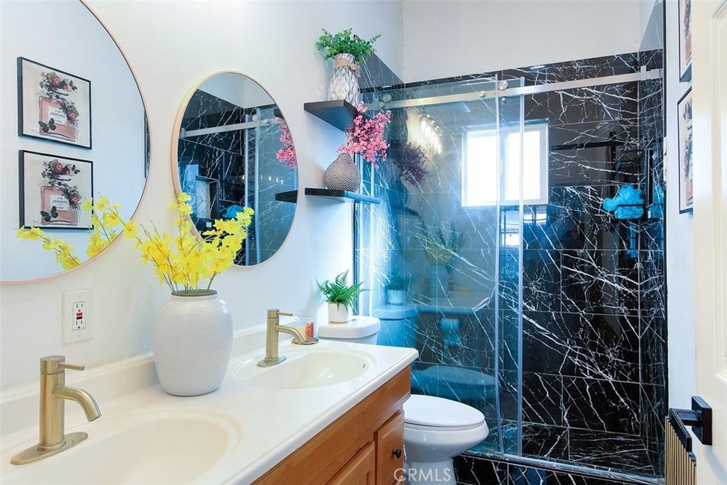 11523 Richeon Avenue Downey, CA 90241 - Photo 13 of 25 a bathroom with a sink a toilet and shower