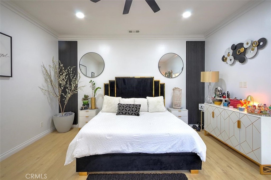 11523 Richeon Avenue Downey, CA 90241 - Photo 16 of 25 a bedroom with a bed and a chandelier