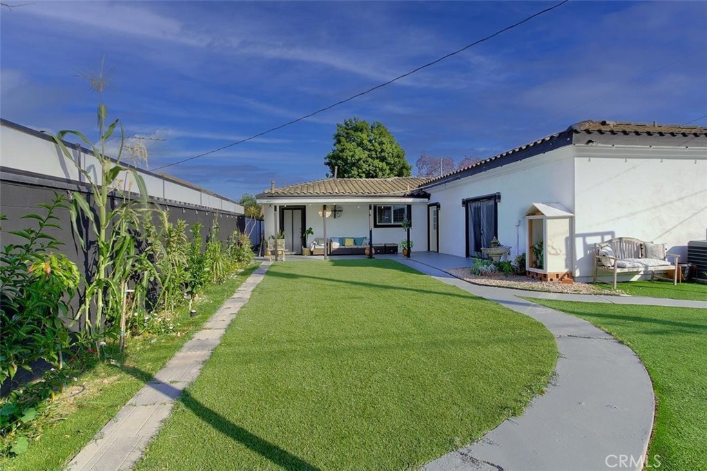 11523 Richeon Avenue Downey, CA 90241 - Photo 22 of 25 a front view of a house with a yard table and chairs