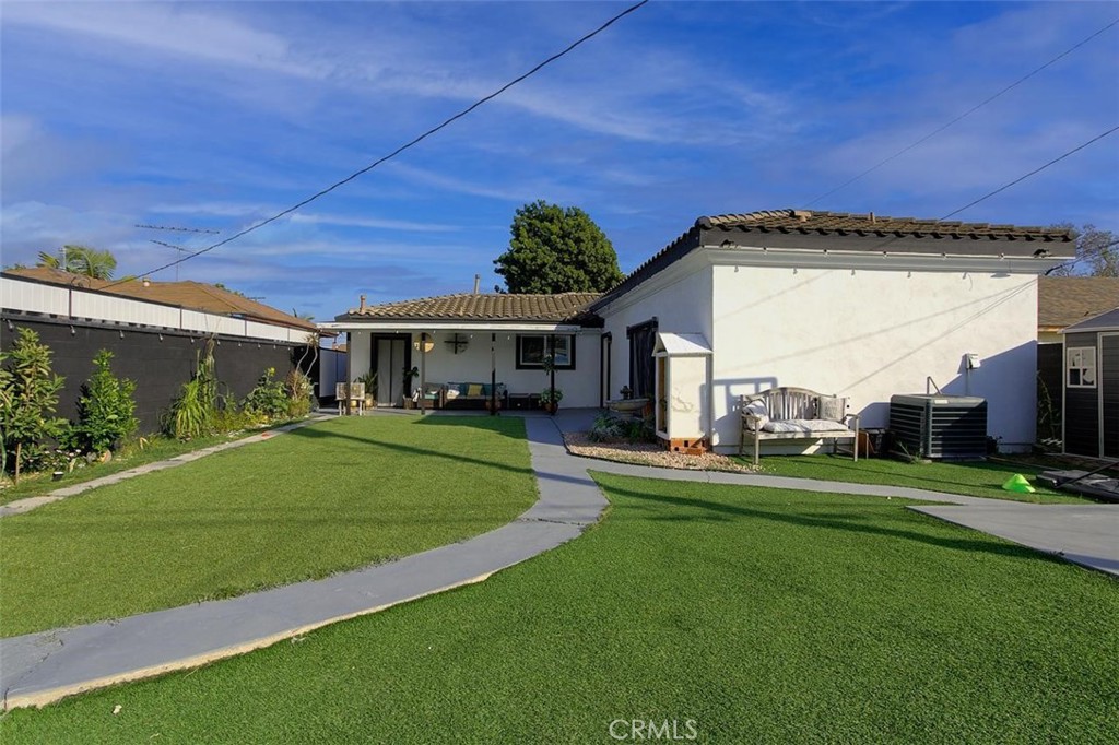 11523 Richeon Avenue Downey, CA 90241 - Photo 23 of 25 a front view of a house with a yard table and chairs
