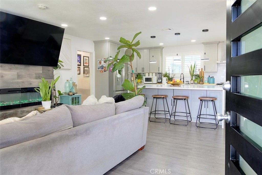 11523 Richeon Avenue Downey, CA 90241 - Photo 4 of 25 a living room with fireplace furniture and a flat screen tv